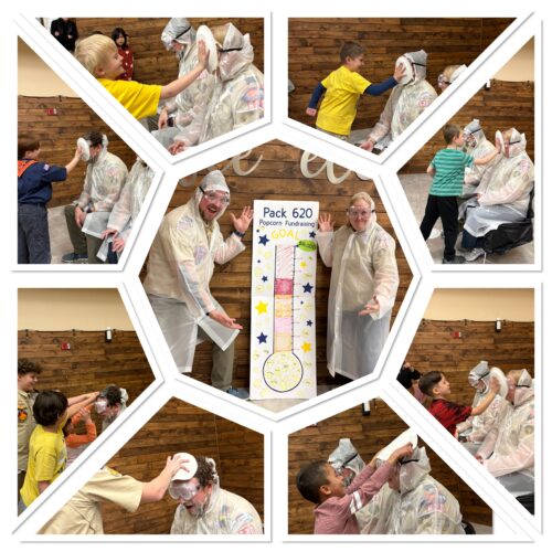 Two Scout leaders getting hit in the face with whipped cream.